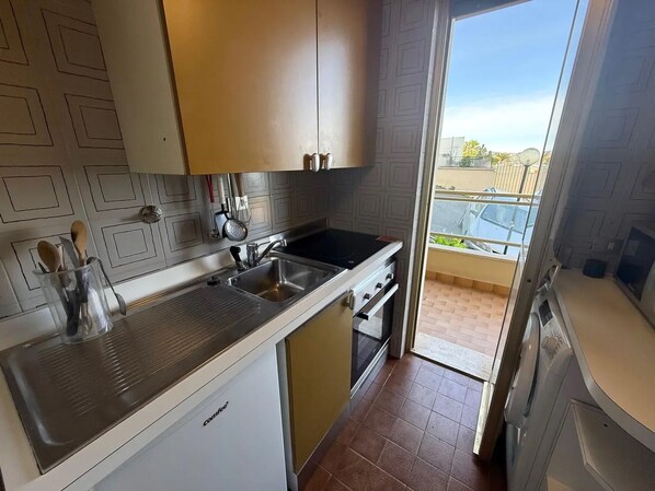 A compact kitchen with a dishwasher, a sink, and a stove. - New Listing (Sanremo)