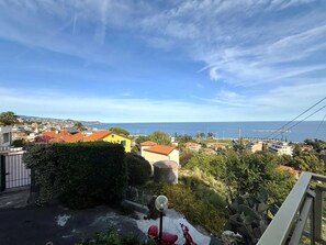 A residential area with houses, a street, and a view of the sea. - New Listing (Sanremo)