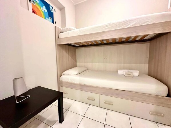 A bunk bed room with a desk and drawers. - New Listing (Sanremo)