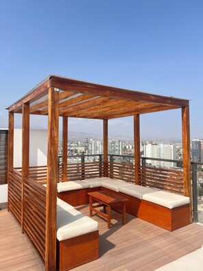A wooden outdoor seating area with a view of the cityscape. - New Listing (Barranco)