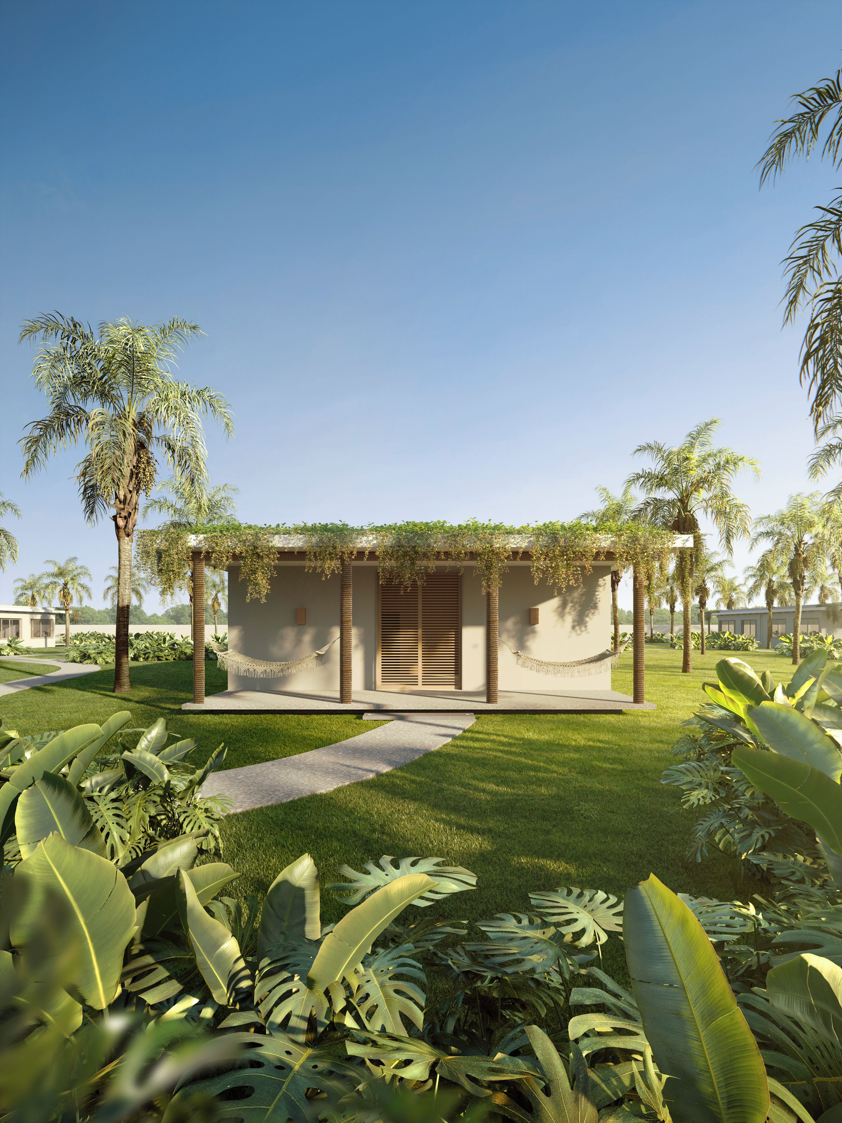 Un edificio moderno con entrada cubierta, rodeado de abundante vegetación y palmeras.
