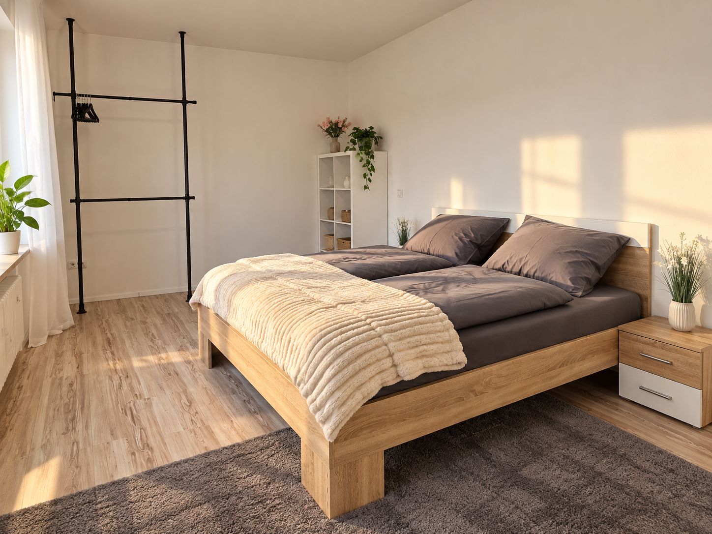 Une chambre à coucher moderne avec un lit en bois, une table de chevet, une commode, une armoire et une plante.