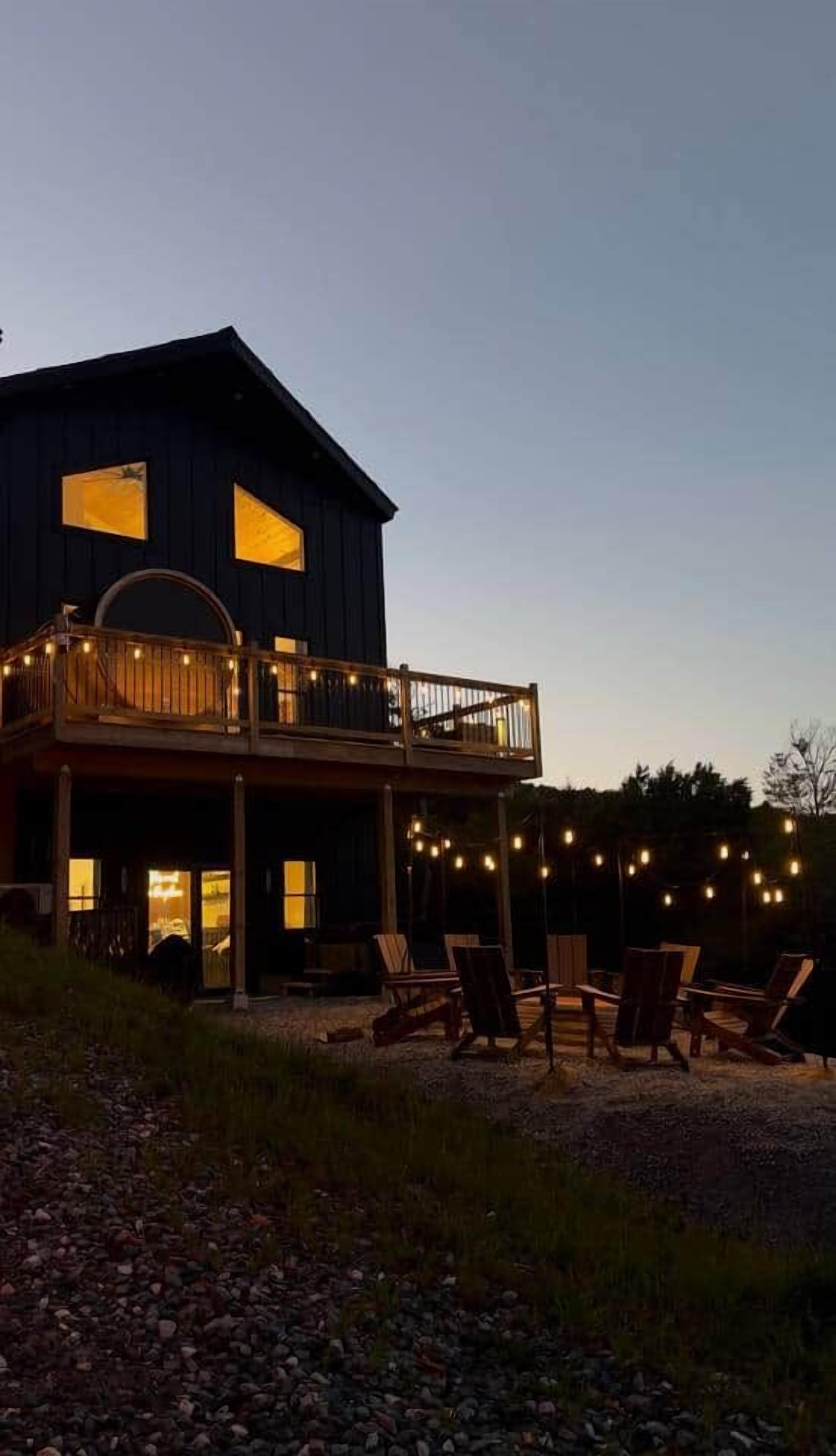 A two-story building with a balcony and outdoor seating area.