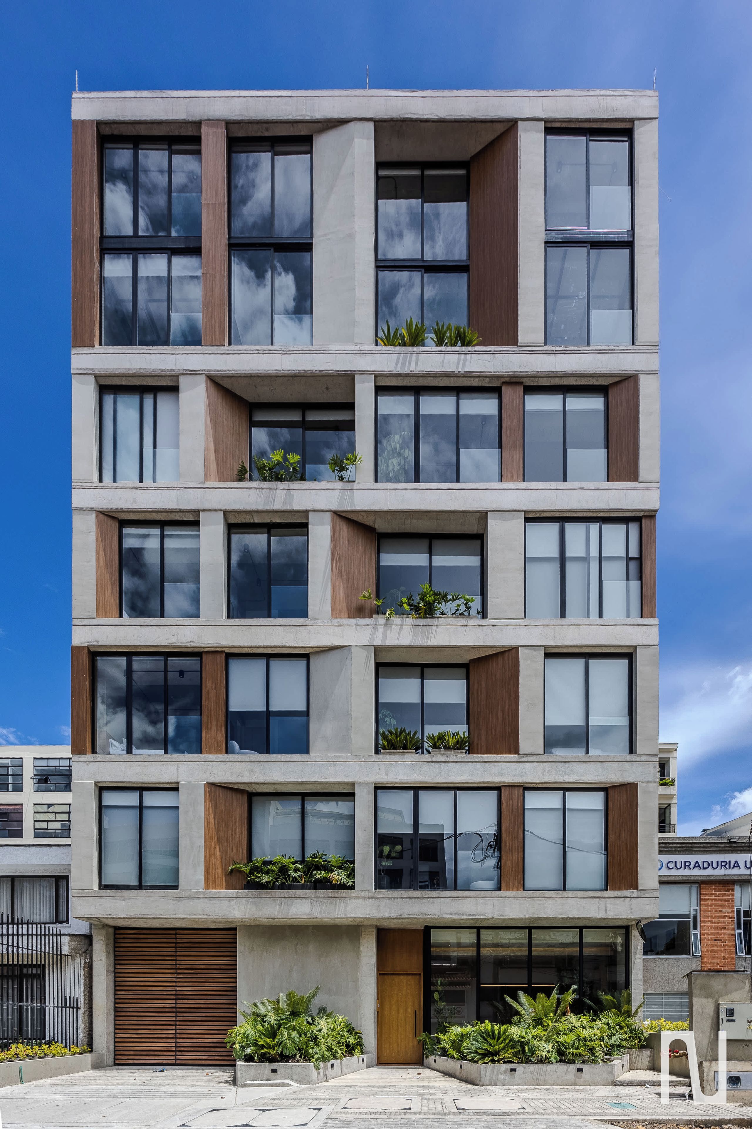 A multi-story building with a flat facade, large windows, and a central entrance.