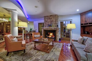 A spacious lobby with a stone fireplace, leather seating, and a modern chandelier. - One King Bedded Suite (Pet Friendly) w/ Balcony & Heated Pool | Hotel Los Gatos (Los Gatos)