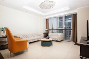 A modern living room with a sofa, a round coffee table, and a chair.