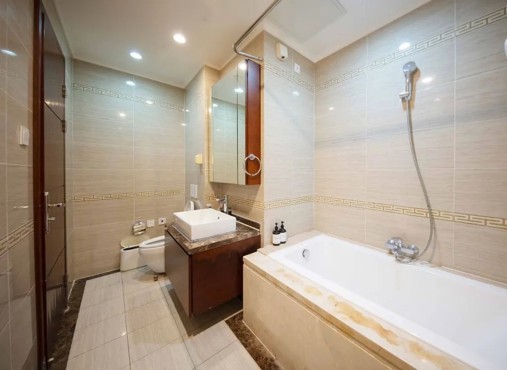 A modern bathroom with a bathtub, a sink, and a shower.