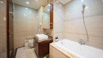 A modern bathroom with a bathtub, a sink, and a shower.