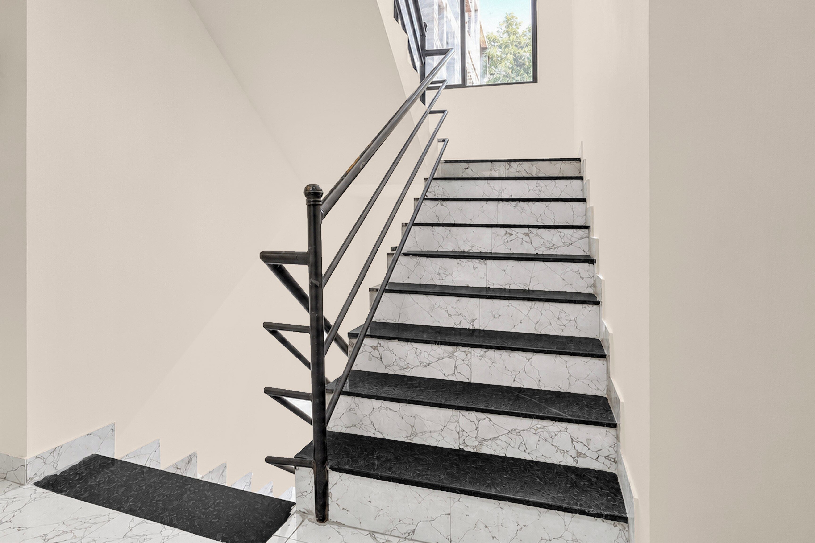 A staircase with marble steps and black handrails.