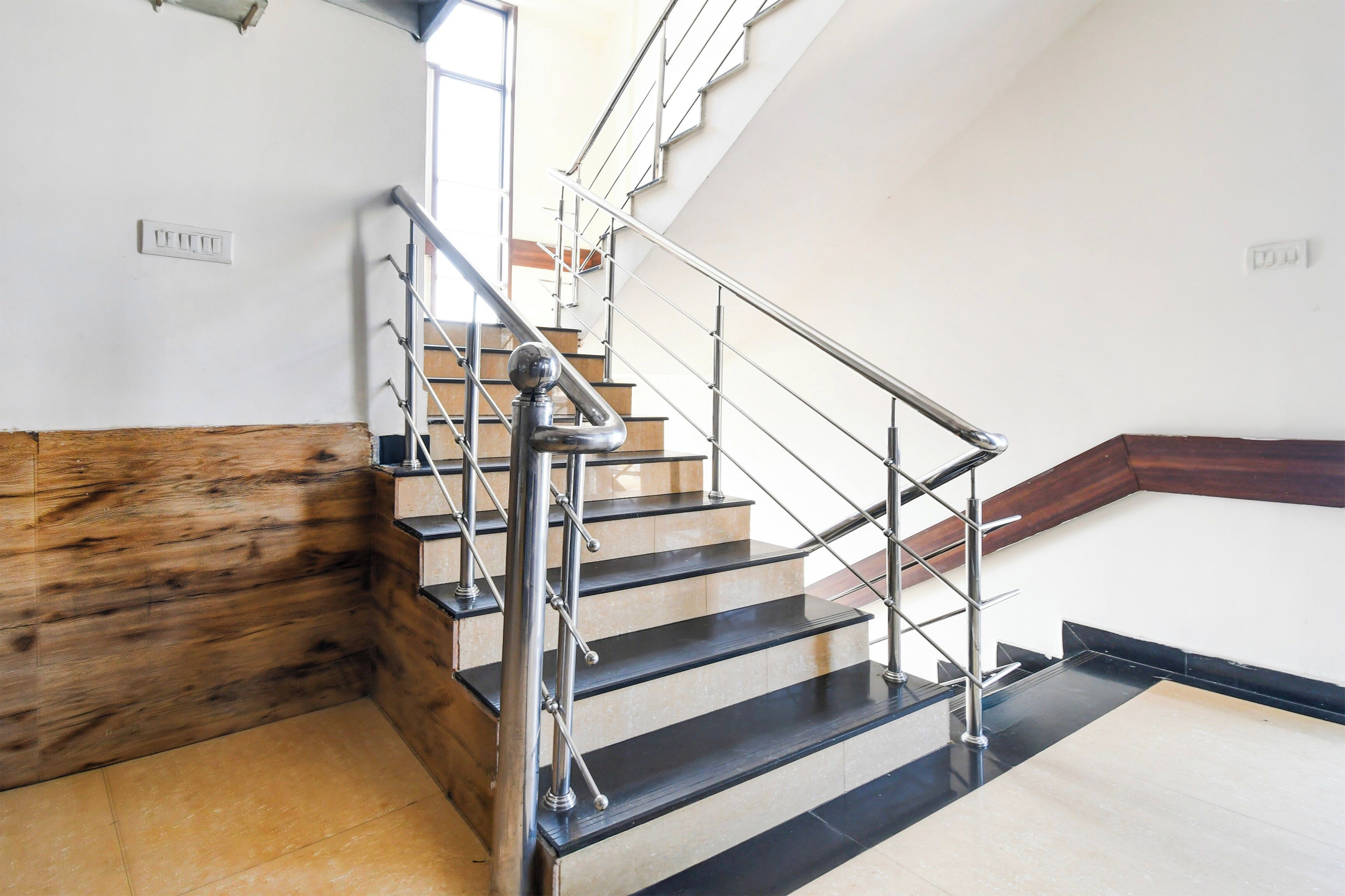 A staircase with a metal handrail and wooden steps.