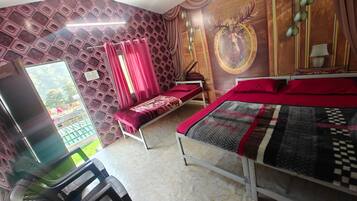 A bedroom with a bed, a desk, and a chair. There is a window with curtains, a wall with a patterned design, and a wall with a circular design.