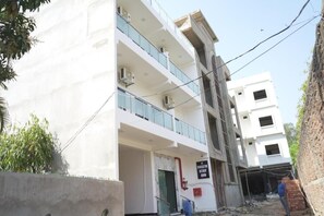 A multi-story building under construction with a sign indicating a Swastik Stay Inn. - Swastik Stay Inn  (Anmol Nagar ,Sarnath ,Varanasi)