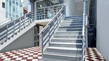 A staircase with metal railings and a checkered floor pattern.