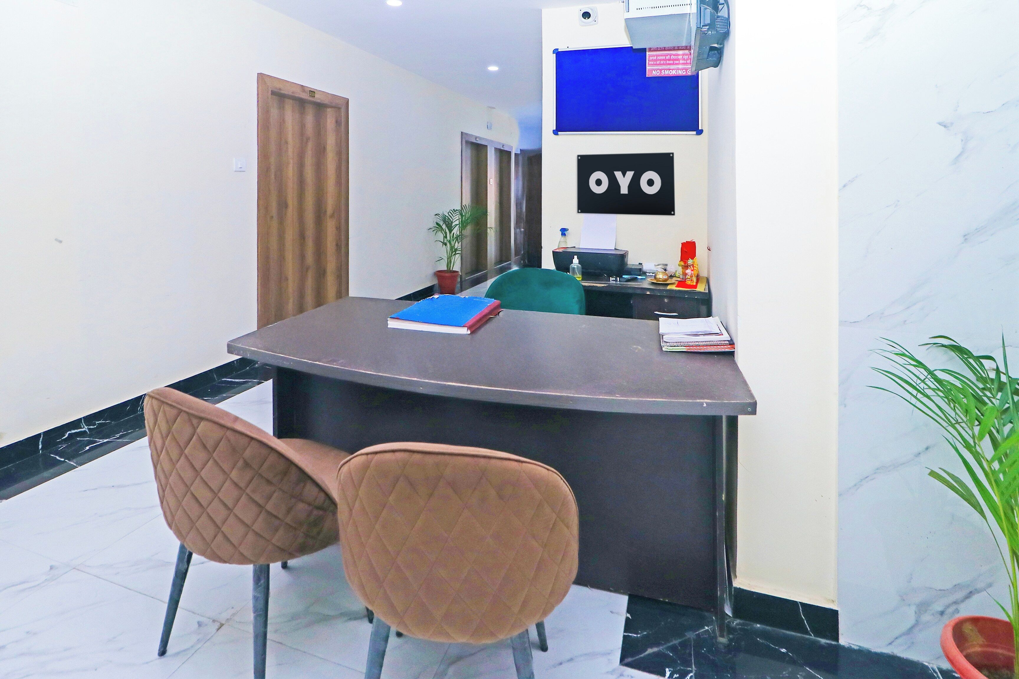 A reception desk with a sign reading 'OYO' in a hotel lobby.