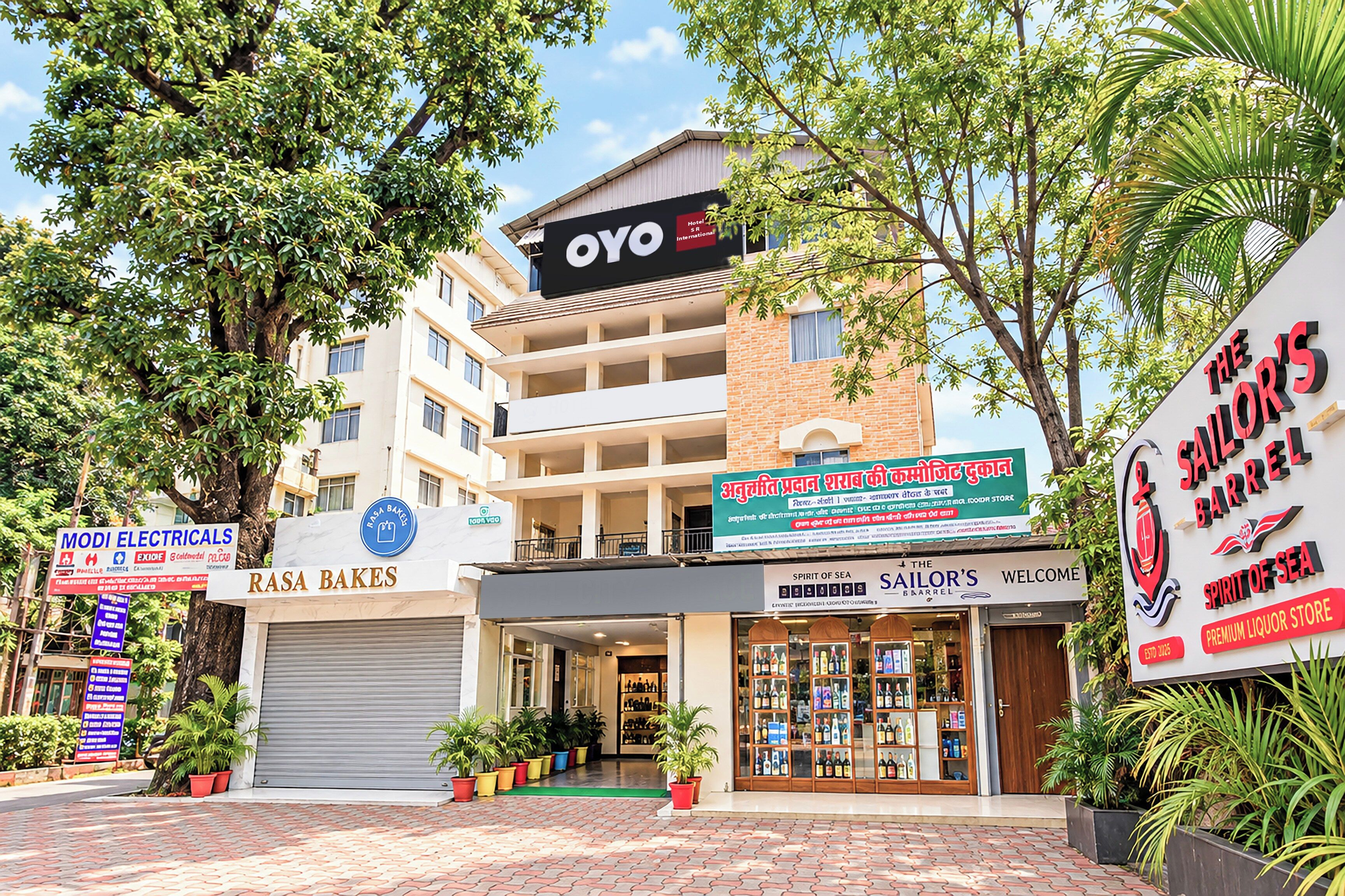 A commercial building with multiple storefronts, including a bakery, a liquor store, and a hotel.