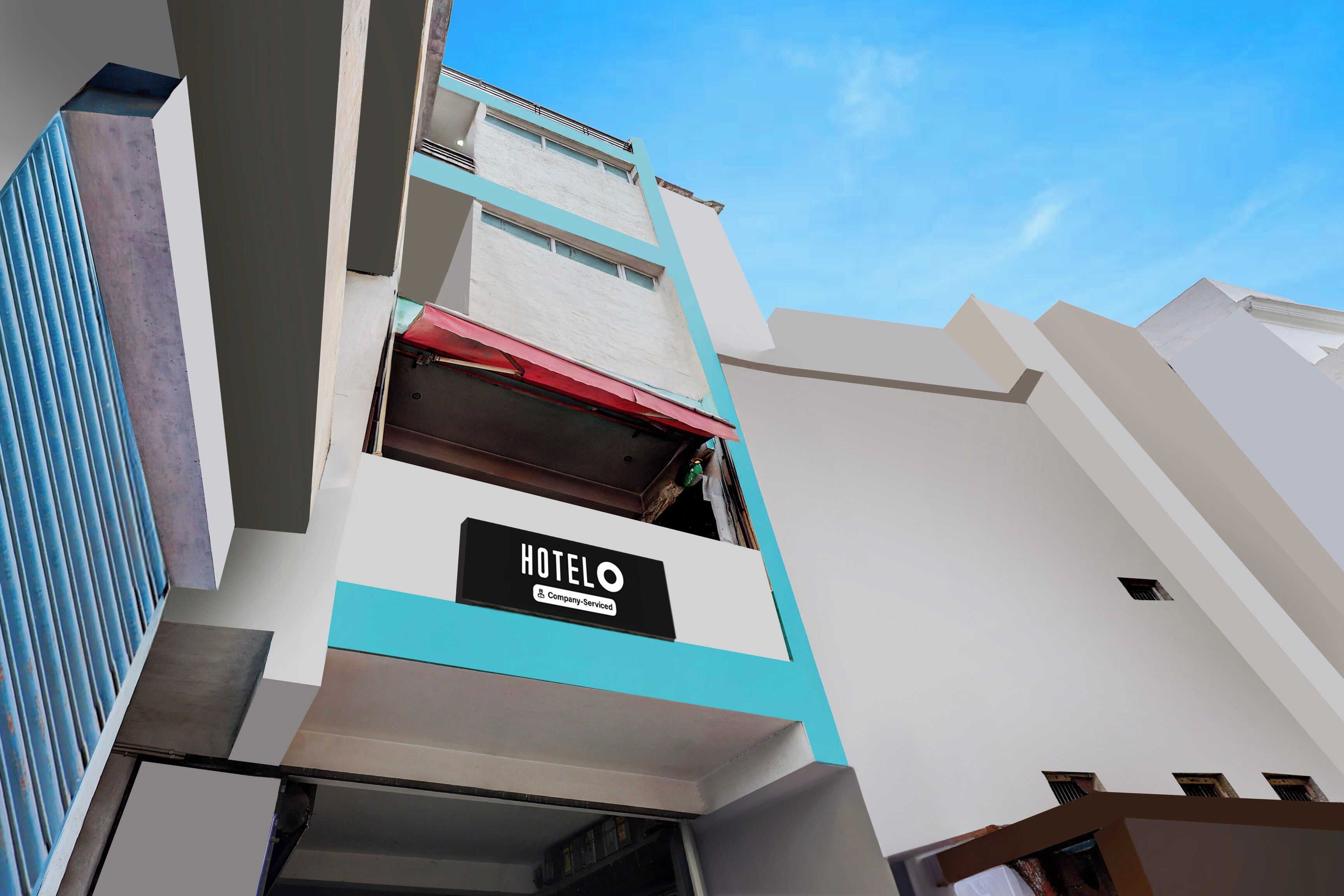 A hotel building with a sign indicating it is company-serviced.