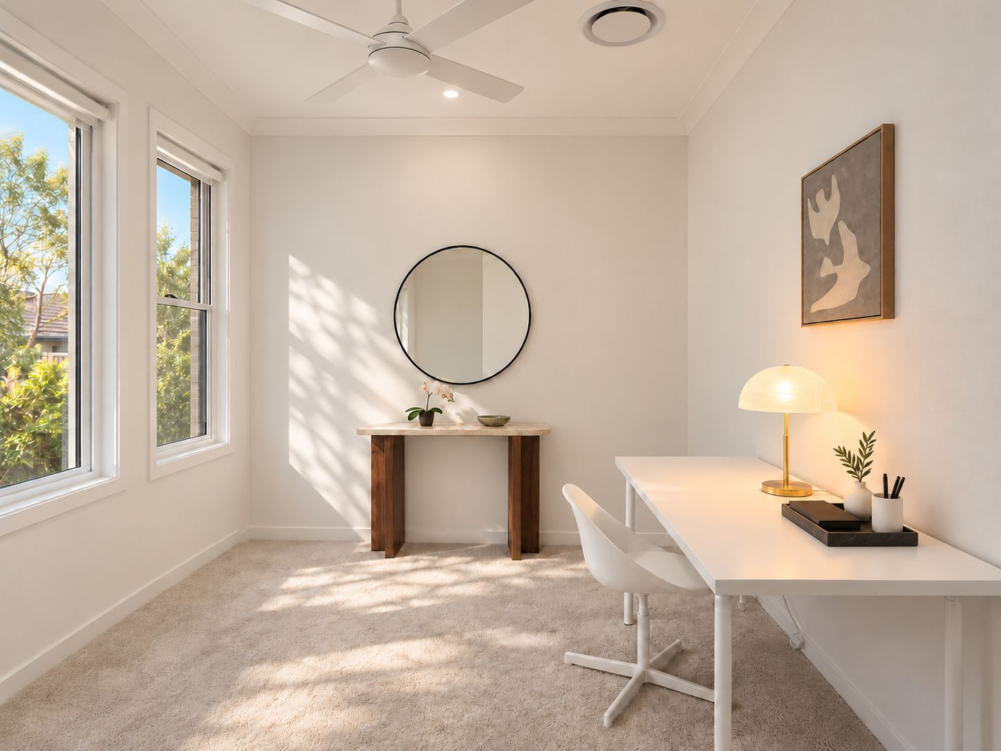 A modern room with a desk, chair, and a round mirror.
