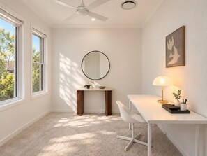 A modern room with a desk, chair, and a round mirror. - Stillwood House | Slow Days, Soft Nights, family home @ park ridge. (Park Ridge)