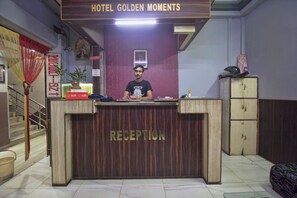 A hotel reception desk with a sign reading 'RECEPTION' and a 'NO CREDIT' sign above it. - Hotel O Golden Moments (Siliguri)