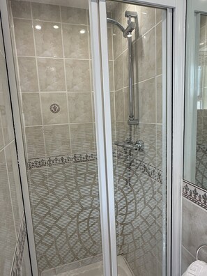 A glass-enclosed shower with a showerhead and control panel. - Granada Apartments Burbage flat 3 1st floor rear (Blackpool FY2 9JS)