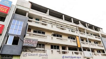 A multi-story building with commercial establishments on the ground floor, including a hotel named 'Lodge' and a restaurant.