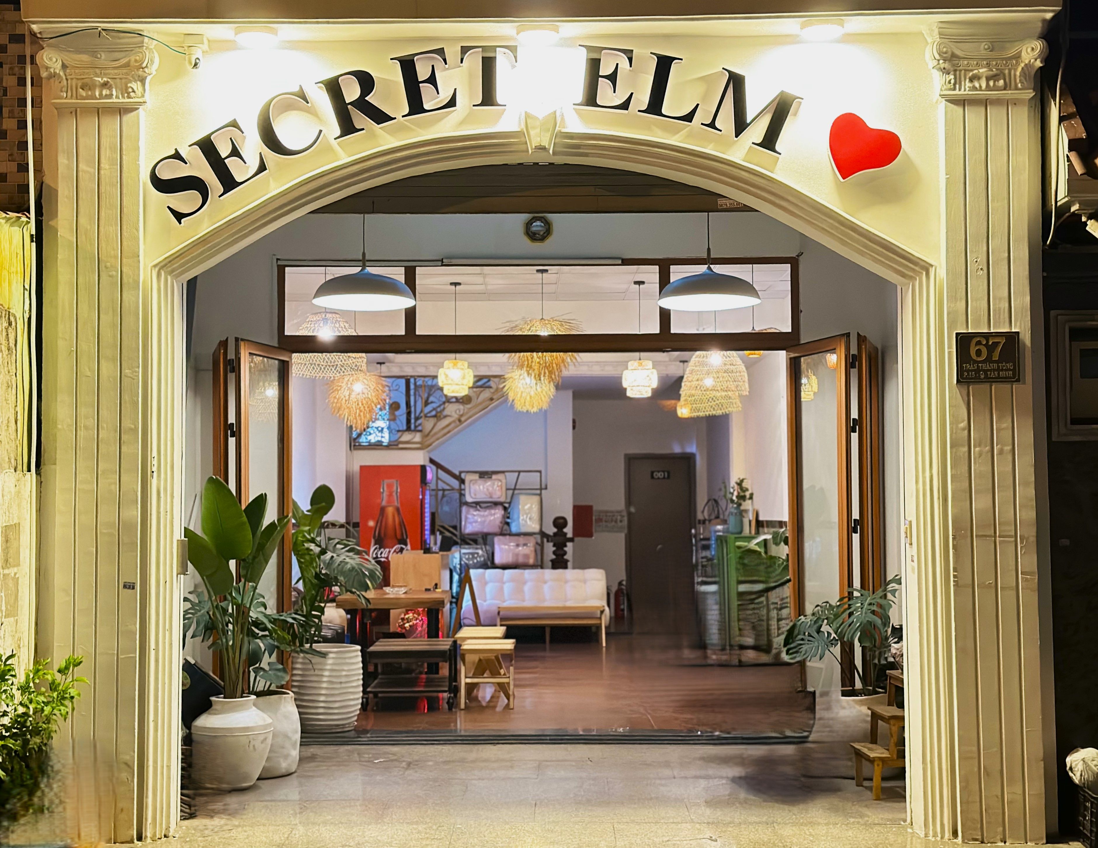 A storefront with the sign 'SECRET ELM' and a heart symbol above it.
