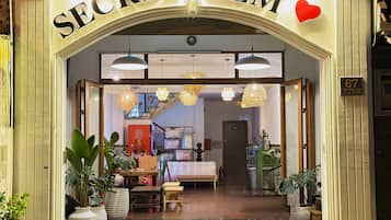 A storefront with the sign 'SECRET ELM' and a heart symbol above it.