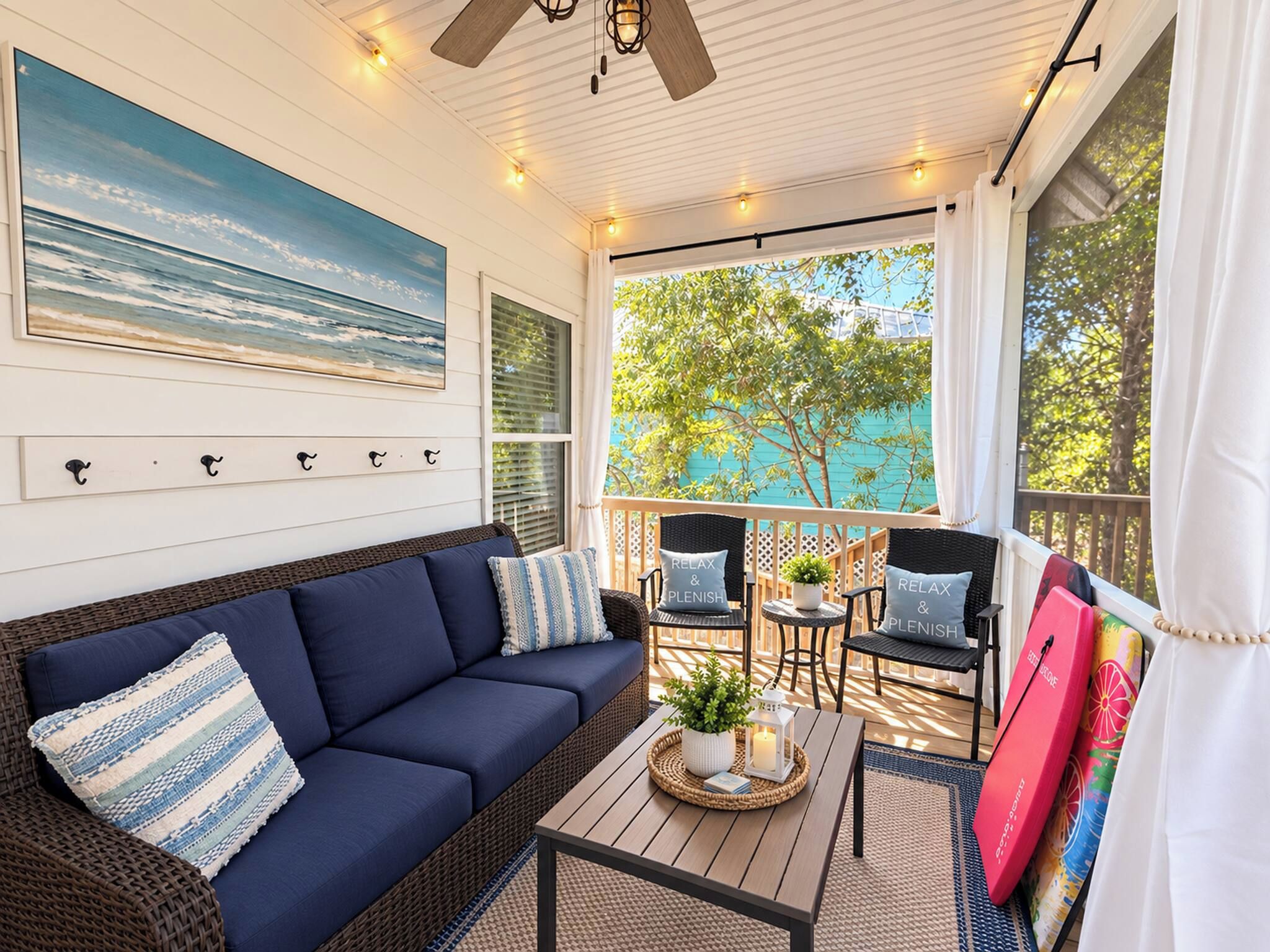 A cozy outdoor seating area with a sofa, chairs, and a table, overlooking a scenic view.