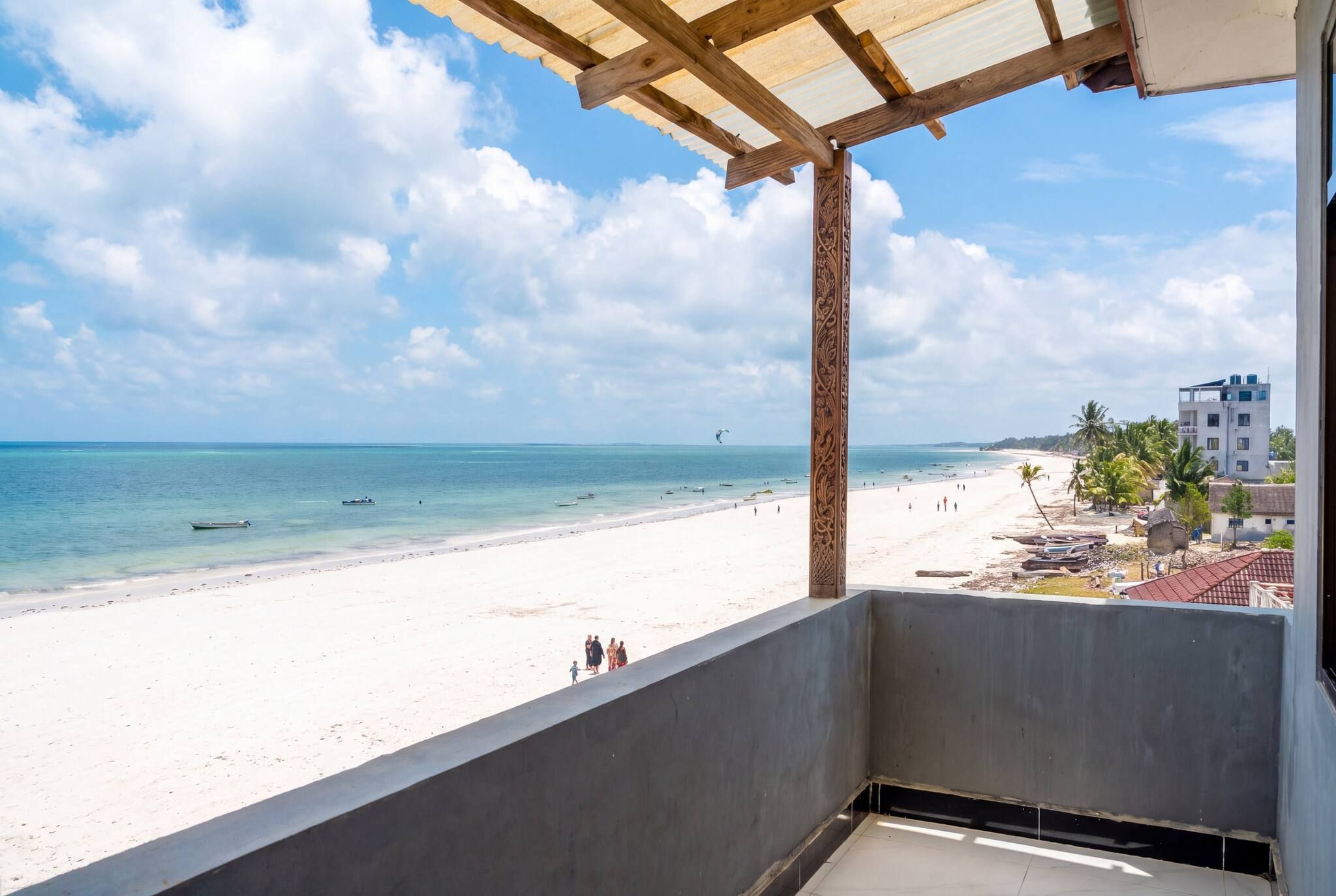 A balcony with a view of a beach and ocean.