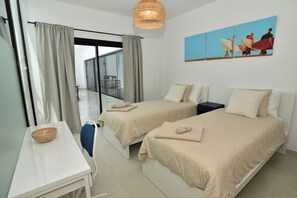 A hotel room with two beds, a dining table, a bowl, and a painting on the wall. - New Listing (La Oliva)