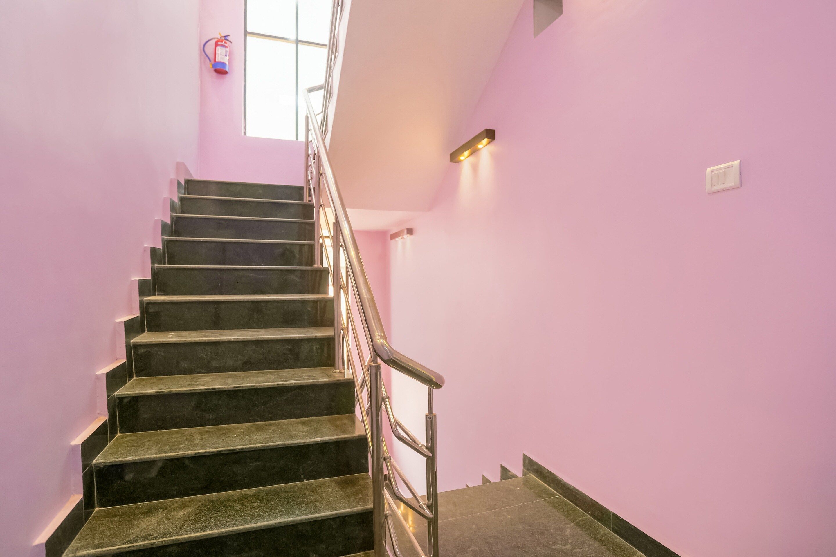 A staircase with a metal railing leading to a landing.