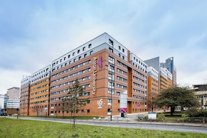 A multi-story building with a prominent university sign, a mix of brick and glass facades, and a flat roof. - Student Only William Murdoch (Birmingham)