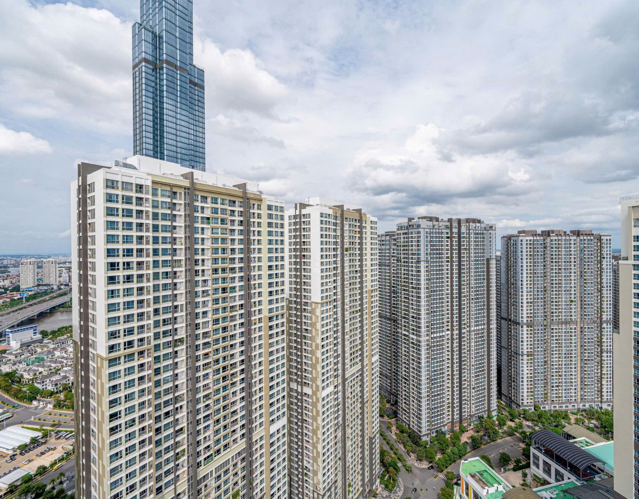 A high-rise residential building with multiple floors, large windows, and a modern architectural design.