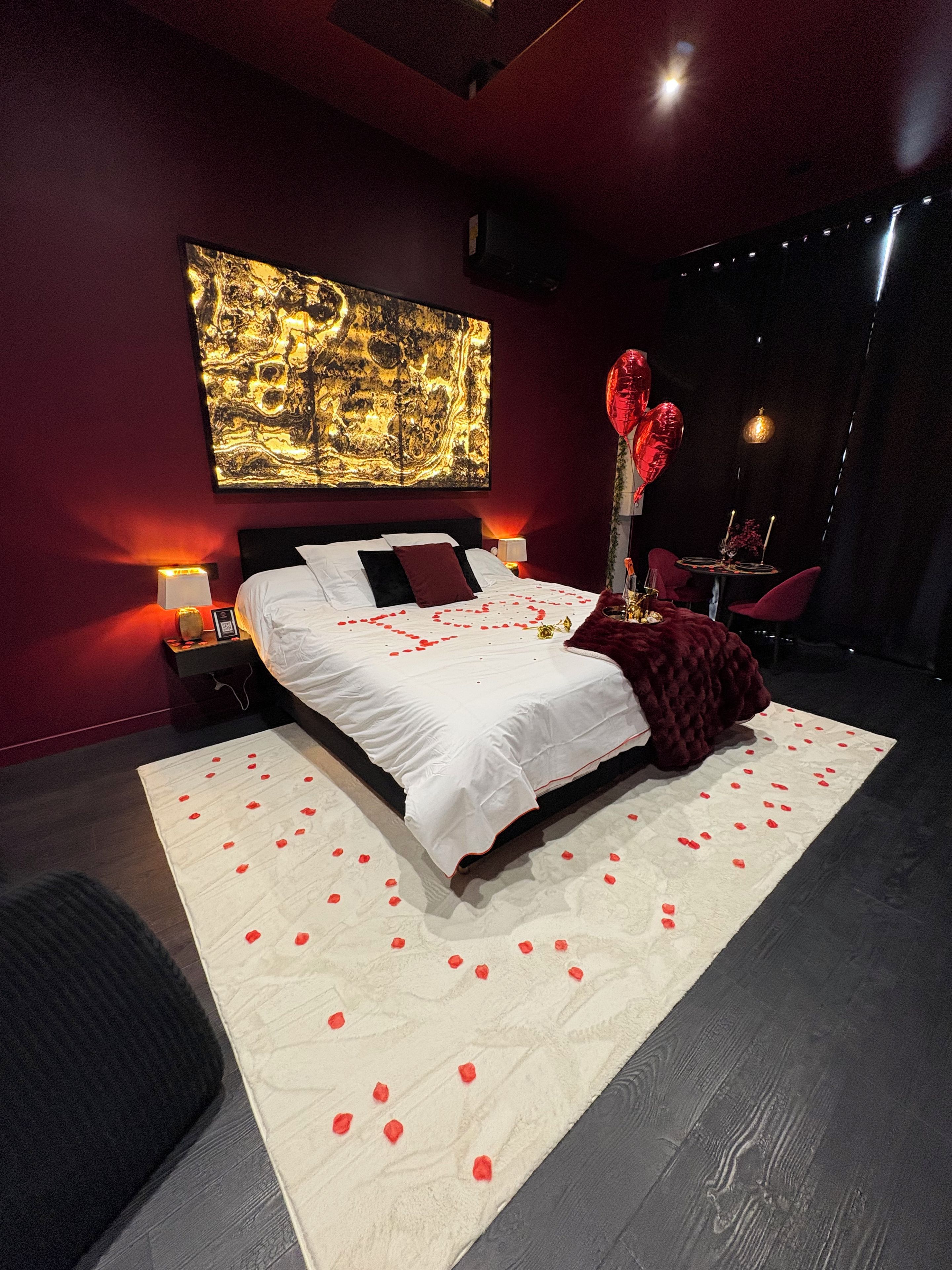A modern bedroom with a large bed, a red carpet, and a wall art piece.