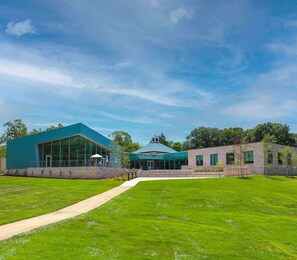 A modern building with a glass facade, a covered entrance, and a well-maintained lawn. - Near Manassas National Battlefield Park + Bistro (Manassas)