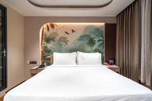 A hotel room with a large bed, a nightstand with a phone, and a wall mural depicting a tropical scene. - Triva By Rcc Hotels Financial District (Hyderabad)