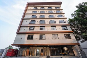 A multi-story building with balconies and large windows. - Triva By Rcc Hotels Financial District (Hyderabad)