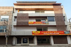 A multi-story building with a sign advertising a Dream Room. - FabHotel Grandeura (Faridabad)