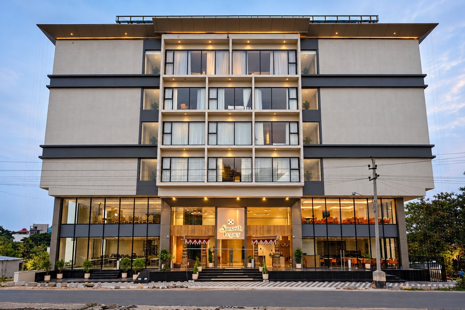 A multi-story hotel with a modern facade, large windows, and a visible entrance with a sign.