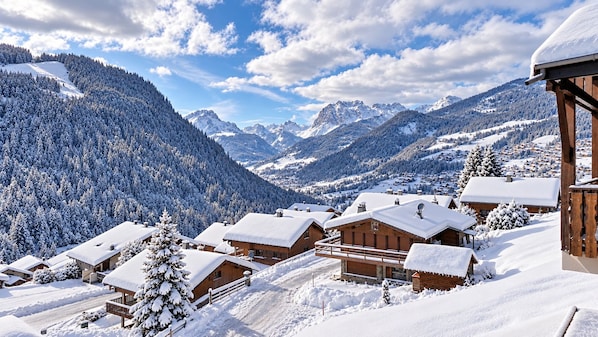 A snow-covered mountain village with wooden buildings and a clear sky. - New Listing (Châtel)
