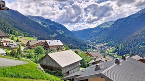 A mountain village with traditional wooden houses, a valley, and a clear sky. - New Listing (Châtel)