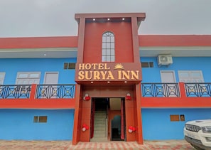 A hotel entrance with a sign reading 'HOTEL SURYA INN' and a vehicle parked in front. - HOTEL O SURYA INN (Varanasi)