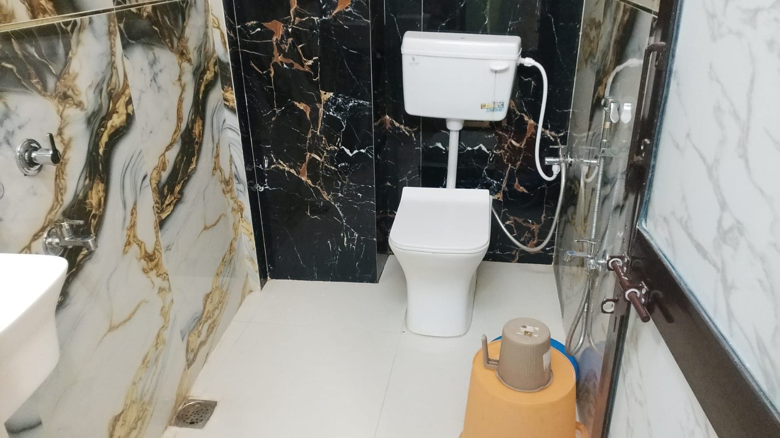 A bathroom with a toilet, sink, and shower.