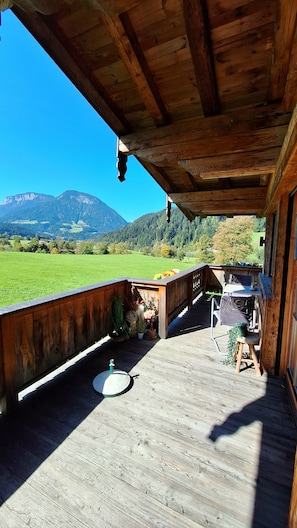 A wooden deck with a view of a mountainous landscape.