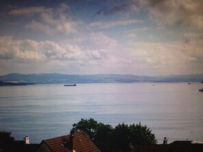 A view of a body of water with a distant landmass and a single boat. - Stunning sea views and scenic walks (Kirn)