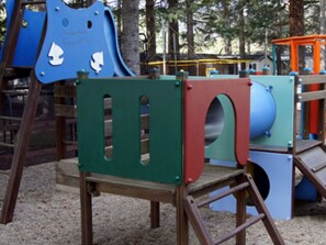 A playground with various play structures including a blue slide and climbing frames. - Mobile home, pets welcome, terrace - 6 guests (Sournia)