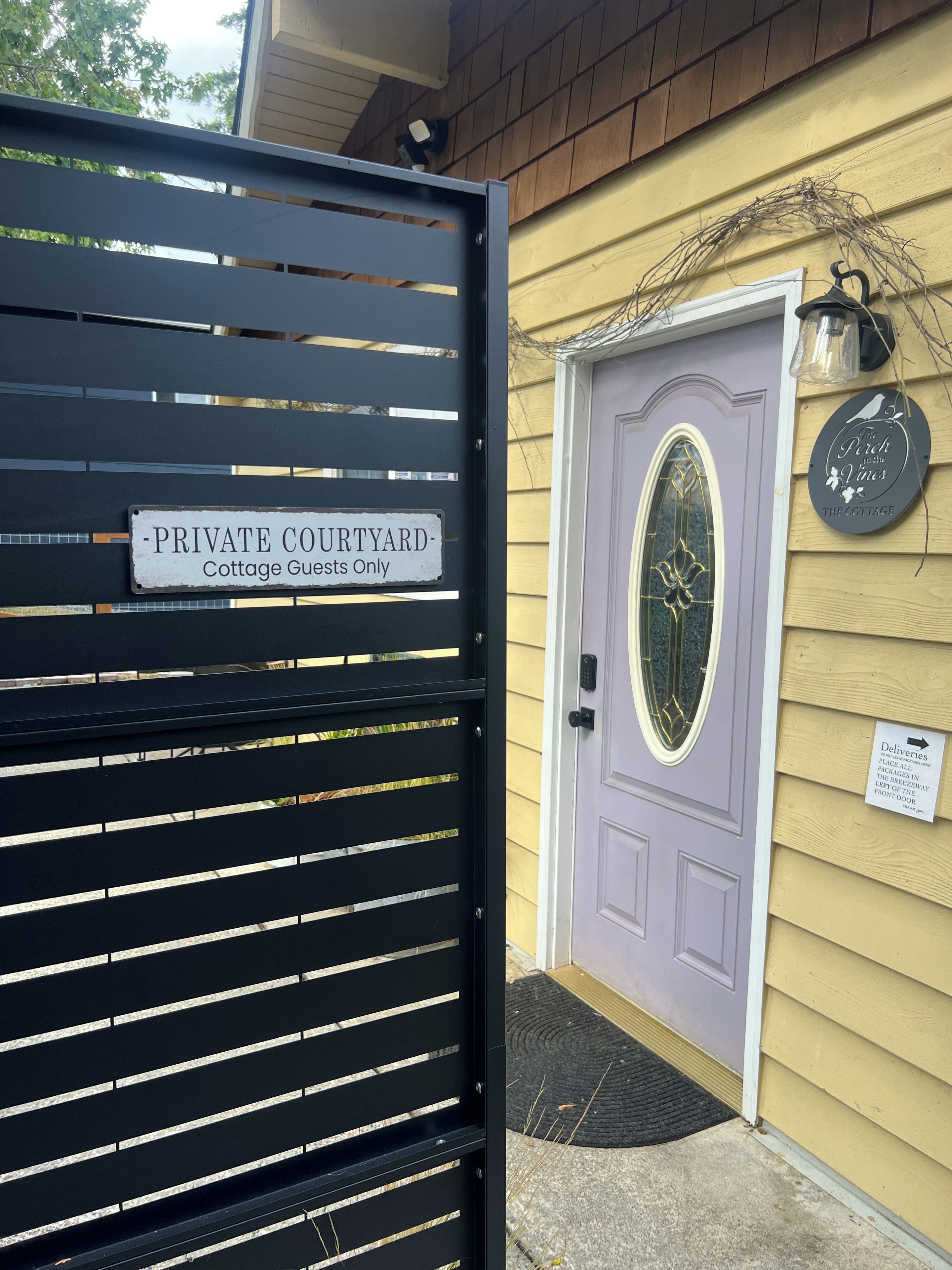 A gated entrance with a sign indicating it is a private courtyard for cottage guests only.