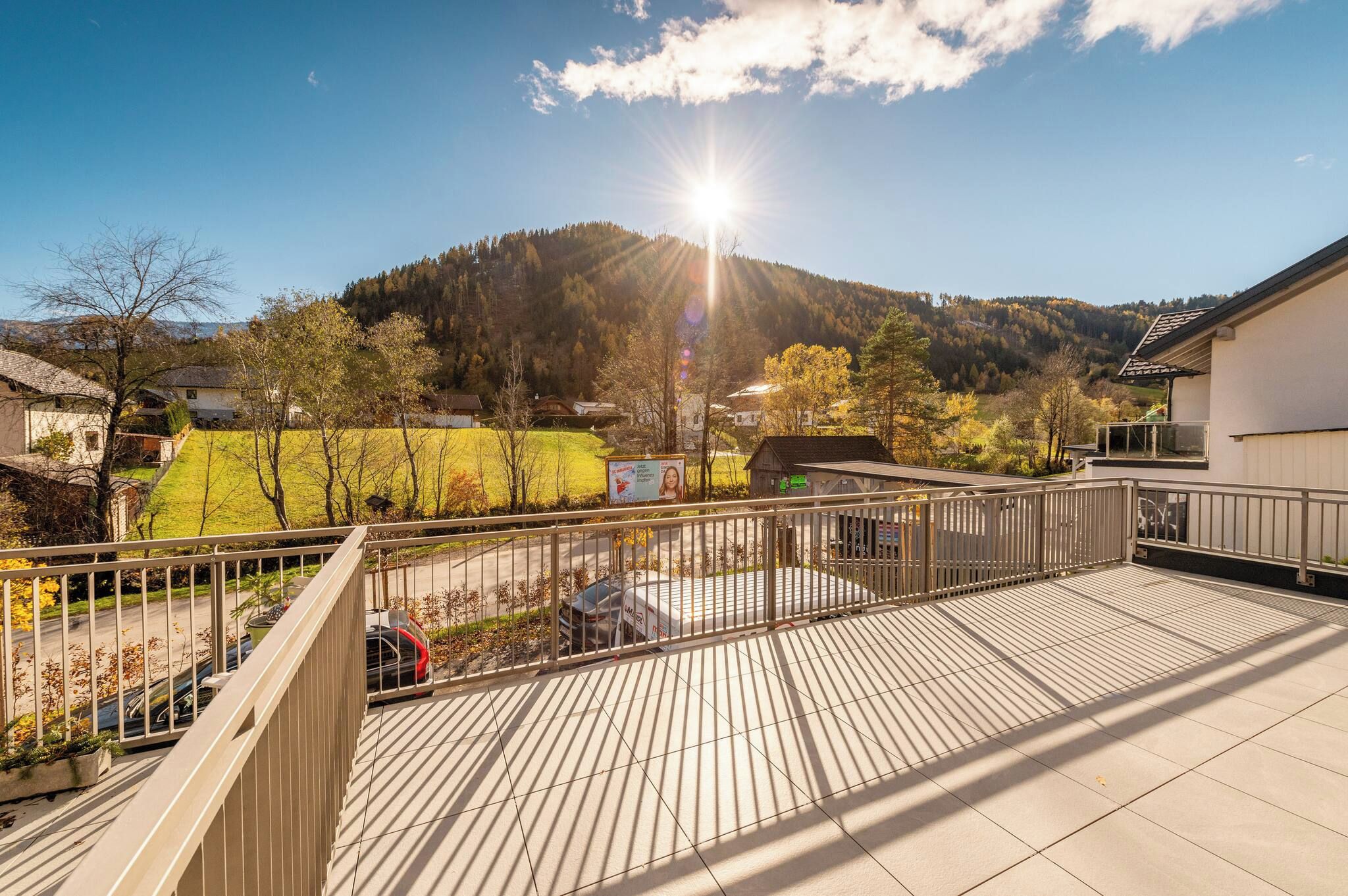 A balcony with a view of a mountain and a clear sky.
