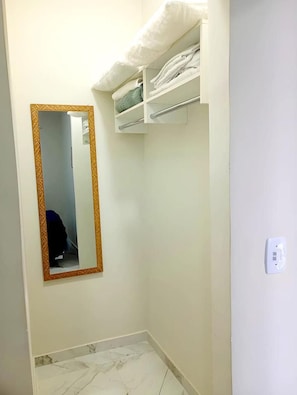 A bathroom with a mirror, a towel rack, and a marble floor. - New Listing (Vila Velha)