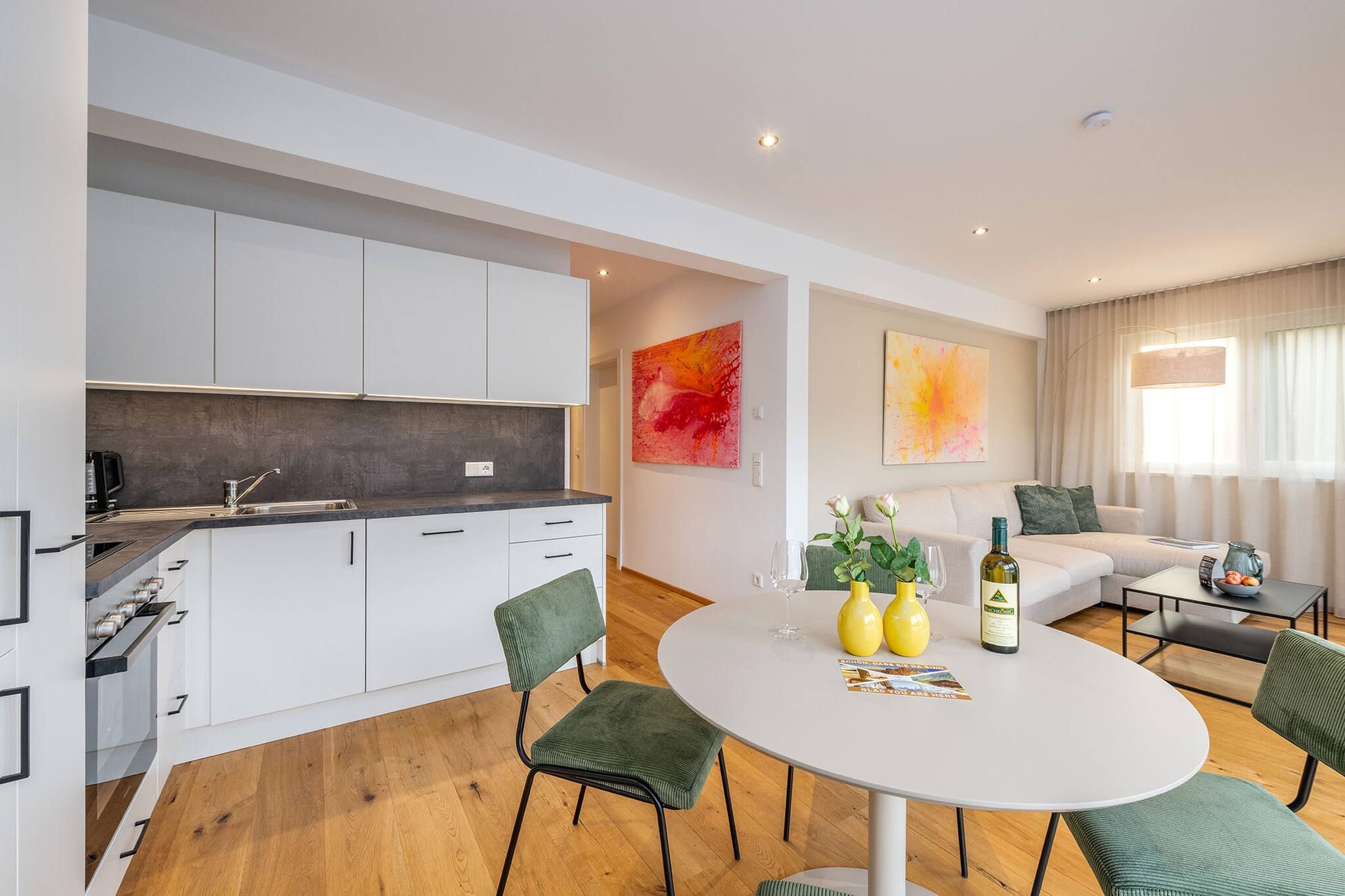 Un appartement moderne comprenant une cuisine, un coin repas et un salon.